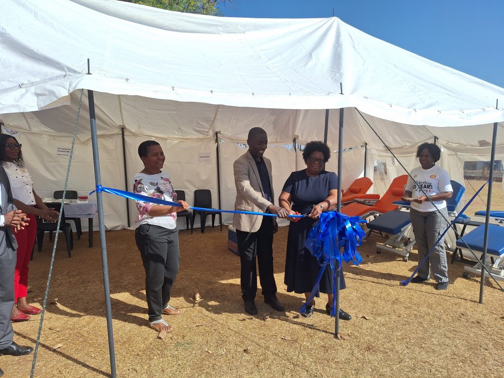 RBM Director Public Relations, Mr Banda, handing over the tent to MBTS Board Chairperson, Mrs Gondwe.